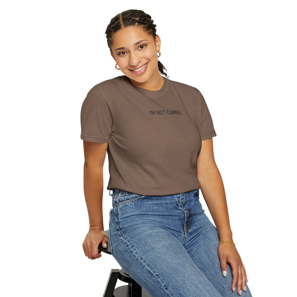 Woman wearing a brown t-shirt with text and blue jeans on a white background