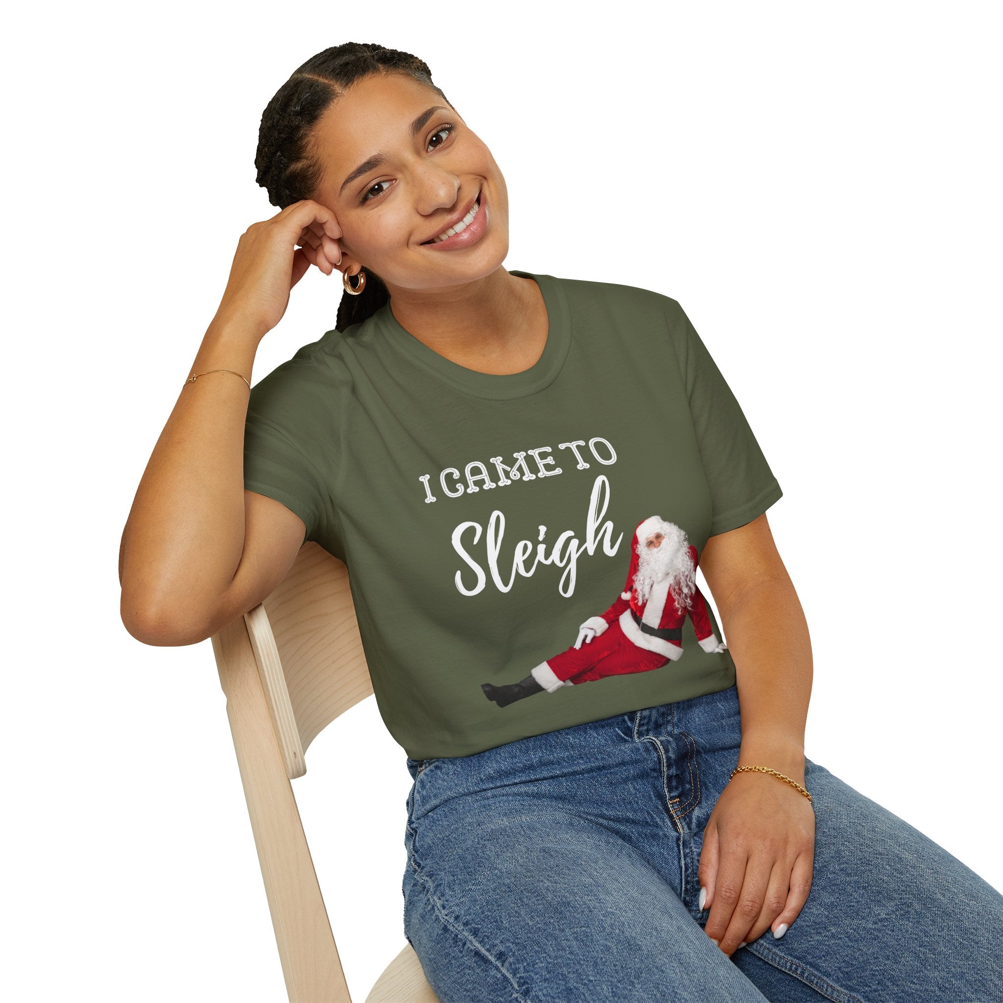 Woman wearing a green t-shirt with a printed design and text, sitting on a chair.